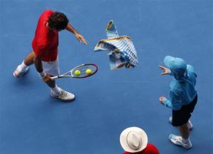 Federer of Switzerland throws his towel to a ball boy after wiping his face at the Australian Open tennis tournament in Melbourne